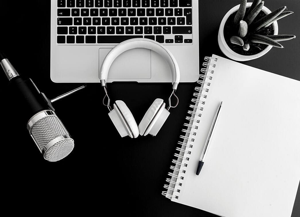 podcast recording concept with audio recording equipment on dark table